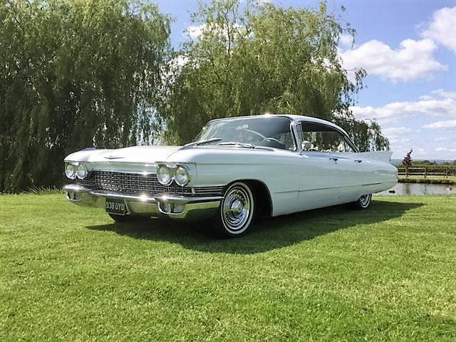 cadillac in sun next to lake venue