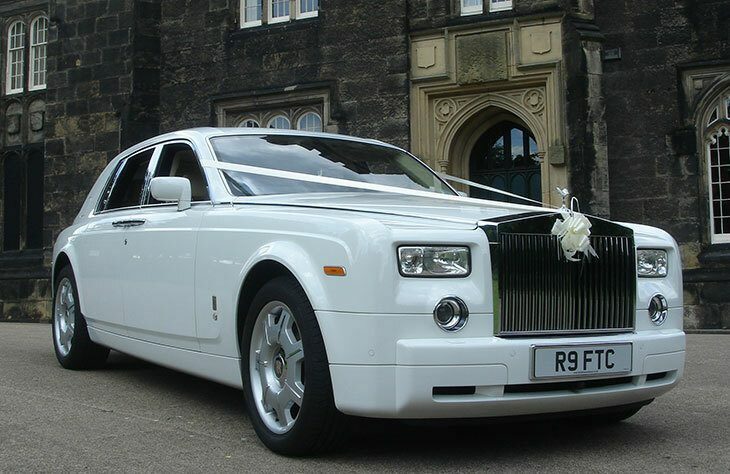 Rolls Royce wedding car with white ribbon adn white finish