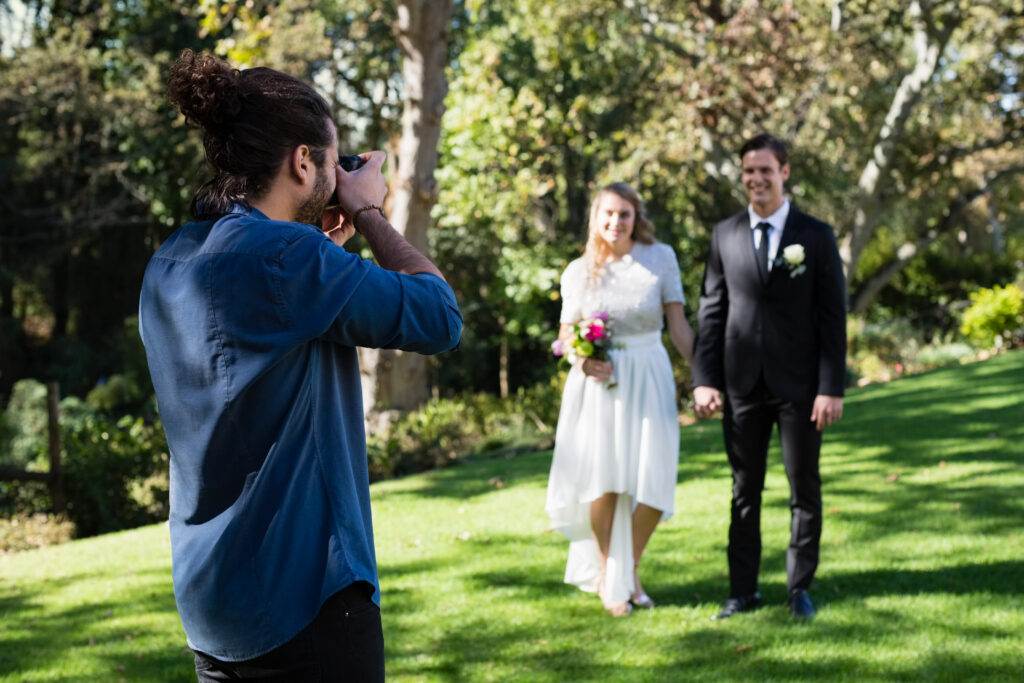 Wedding Photographer taking photo of newly married couple